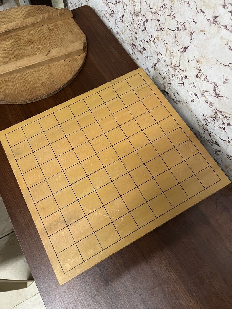 Wooden Go Board Goban Tabletop Strategy Game (Category: Board Games & Puzzles) located in Manila. Submitted by kayerrr.gem (Listing ID 1471049331, Image 3). Description: - Material: Solid wood with standard grid lines - Features: Protective rubber feet to prevent table scratches - Condition: Light surface wear and minor scratches from regular gameplay - Status: Ready for matches.