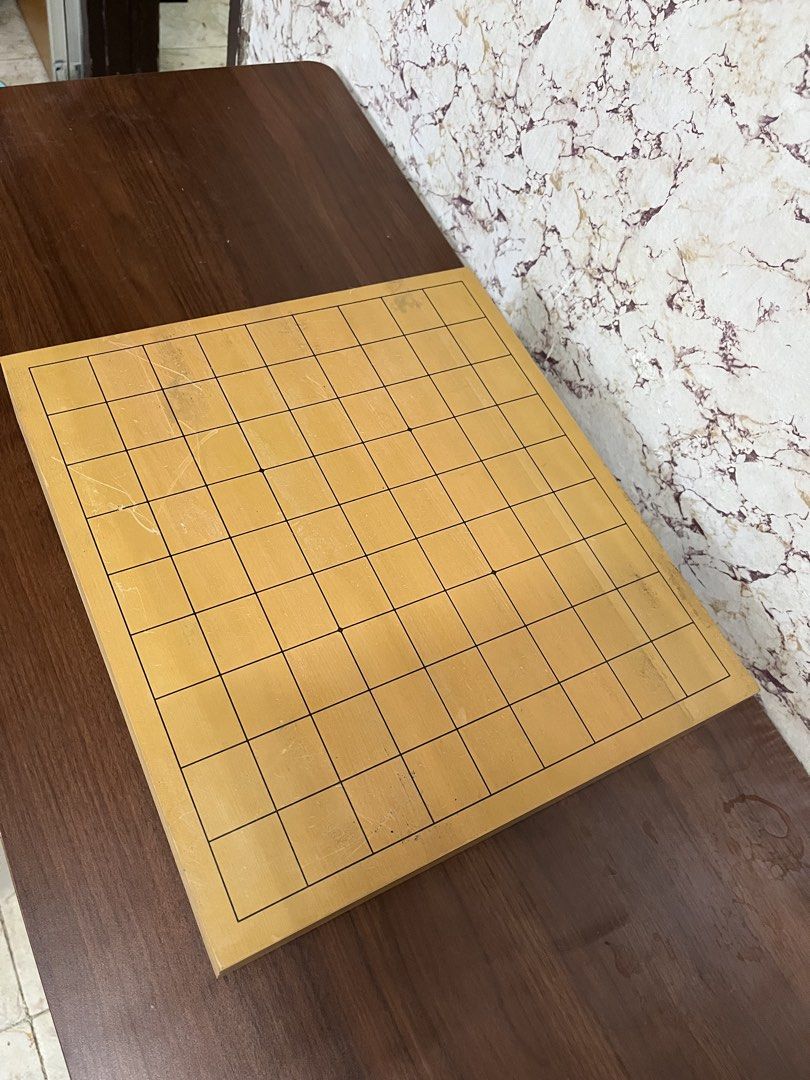 Wooden Go Board Goban Tabletop Strategy Game (Category: Board Games & Puzzles) located in Manila. Submitted by kayerrr.gem (Listing ID 1471049331, Image 1). Description: - Material: Solid wood with standard grid lines - Features: Protective rubber feet to prevent table scratches - Condition: Light surface wear and minor scratches from regular gameplay - Status: Ready for matches.