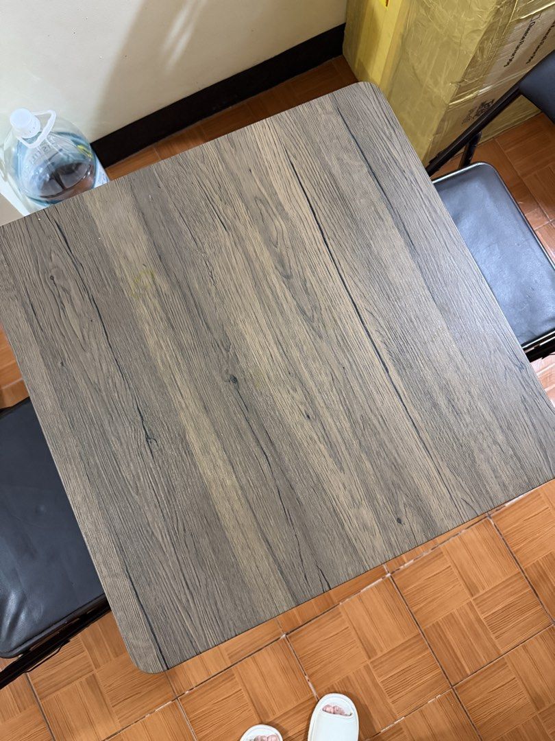 Wooden Table and Two Folding Chairs Set (Category: Tables & Sets) located in Manila. Submitted by shescarmeleve (Listing ID 1471078883, Image 3). Description: - Space-saving square folding table with wood-grain laminate top - Includes 2 matching brown folding chairs with comfortable padded seats - Durable dark metal frames on all pieces - Compact design, extremely easy to fold and store away - Condition: Light tear on one of the chair, still very