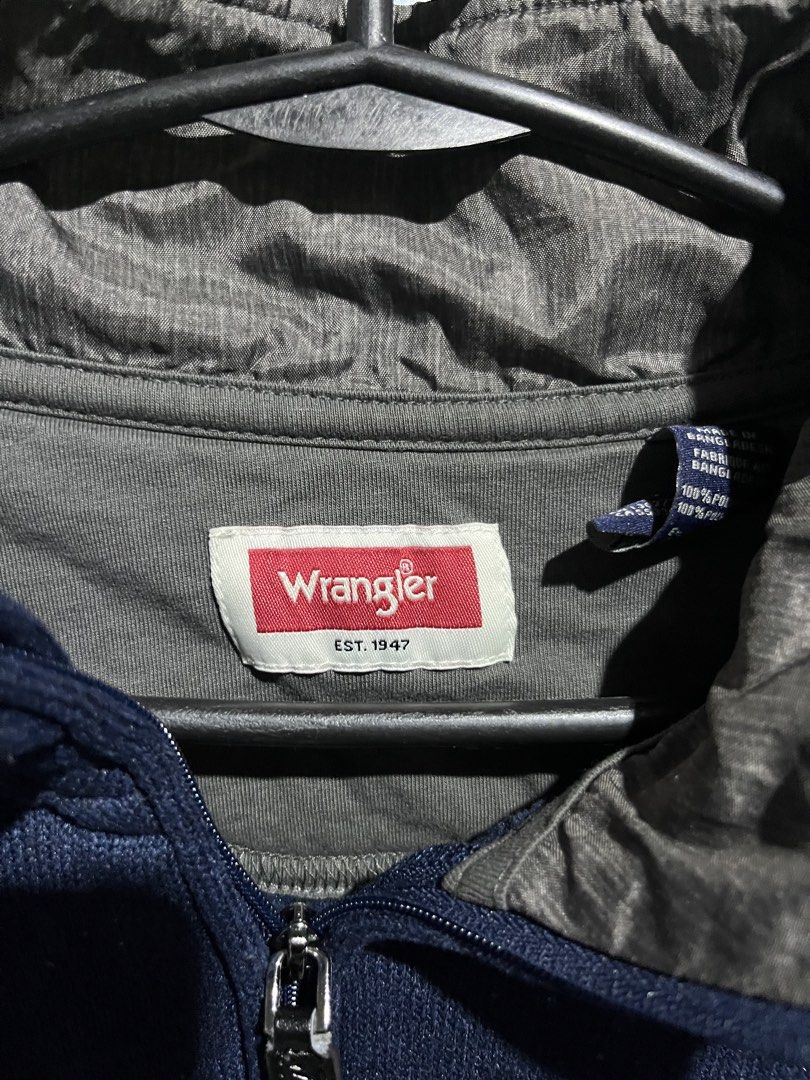 Wrangler Quarter Zip (Category: Coats, Jackets and Outerwear) located in Manila. Submitted by cosmicwolf-85c6 (Listing ID 1471046803, Image 2). Description: - Brand: Wrangler - Color: Navy blue with grey inner collar lining - Details: Embroidered 'W' logo on left chest, silver-toned metal zipper pull - Fit/Use: Comfortable layering piece for cooler weather.