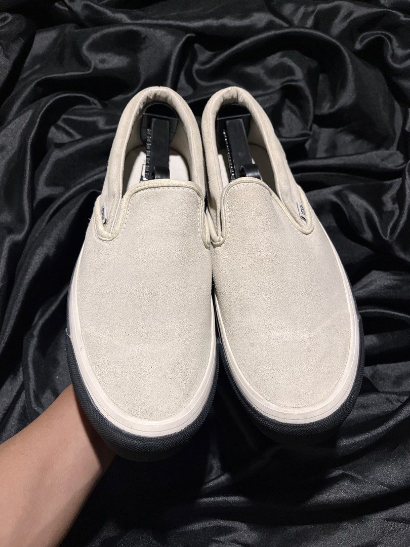 WTAPS x Vans Vault OG Slip-On LX (Category: Sneakers) located in Consolacion. Submitted by archerowar_20 (Listing ID 1471094027, Image 2). Description: WTAPS and Vans collaboration slip-on sneakers. Off-white suede upper with black foxing tape printed with GPS coordinates. WTVUA embroidered text on the heel counters. Classic gum waffle outsoles. Shows minor wear on the bottom tread, otherwise clean uppers and clean midsides..