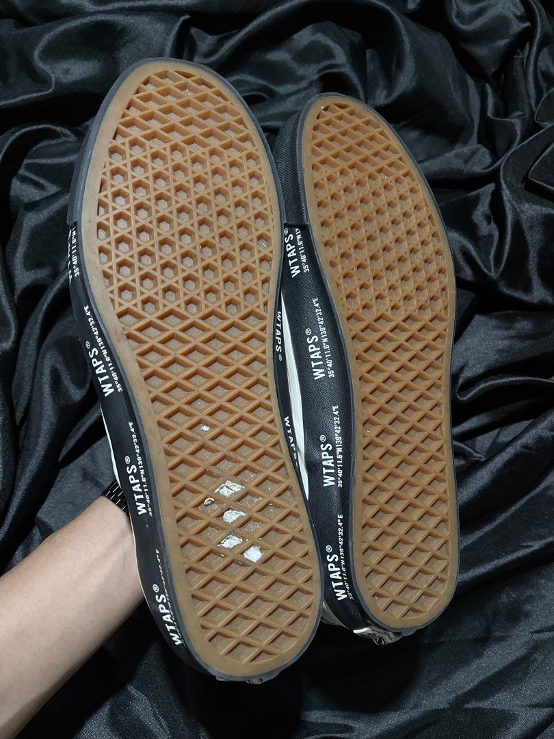 WTAPS x Vans Vault OG Slip-On LX (Category: Sneakers) located in Consolacion. Submitted by archerowar_20 (Listing ID 1471094027, Image 3). Description: WTAPS and Vans collaboration slip-on sneakers. Off-white suede upper with black foxing tape printed with GPS coordinates. WTVUA embroidered text on the heel counters. Classic gum waffle outsoles. Shows minor wear on the bottom tread, otherwise clean uppers and clean midsides..