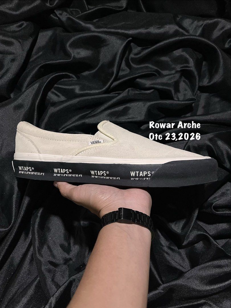 WTAPS x Vans Vault OG Slip-On LX (Category: Sneakers) located in Consolacion. Submitted by archerowar_20 (Listing ID 1471094027, Image 1). Description: WTAPS and Vans collaboration slip-on sneakers. Off-white suede upper with black foxing tape printed with GPS coordinates. WTVUA embroidered text on the heel counters. Classic gum waffle outsoles. Shows minor wear on the bottom tread, otherwise clean uppers and clean midsides..