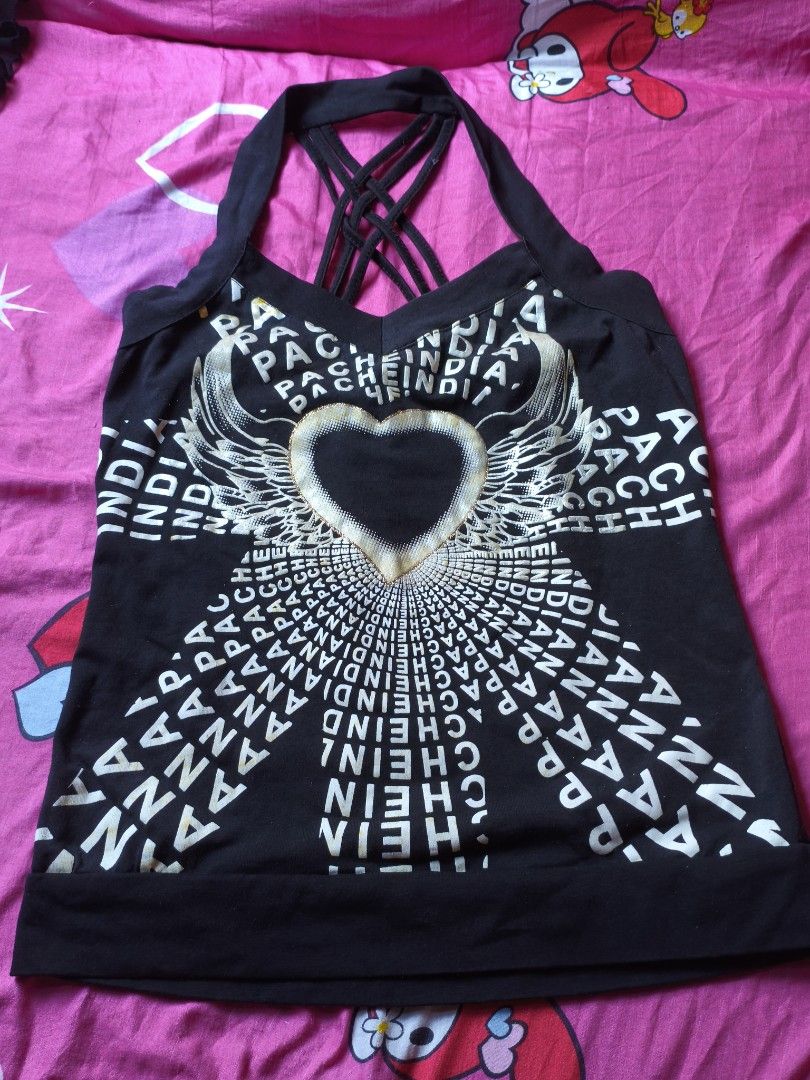 y2k crisscross halter top (Category: Others Tops) located in Manila. Submitted by avwilynn (Listing ID 1471003461, Image 1). Description: *Black Y2K Halter Tank Top - Criss-Cross Back* McBling / Y2K style tank top. *Details:* - *Color:* Black - *Design:* Halter neck with thick band. Graphic print on front - heart with wings and text "PACHE INDIA" repeated, metallic silver/gold foil print - *Back:* Sexy criss-cross strappy back, open back style. H