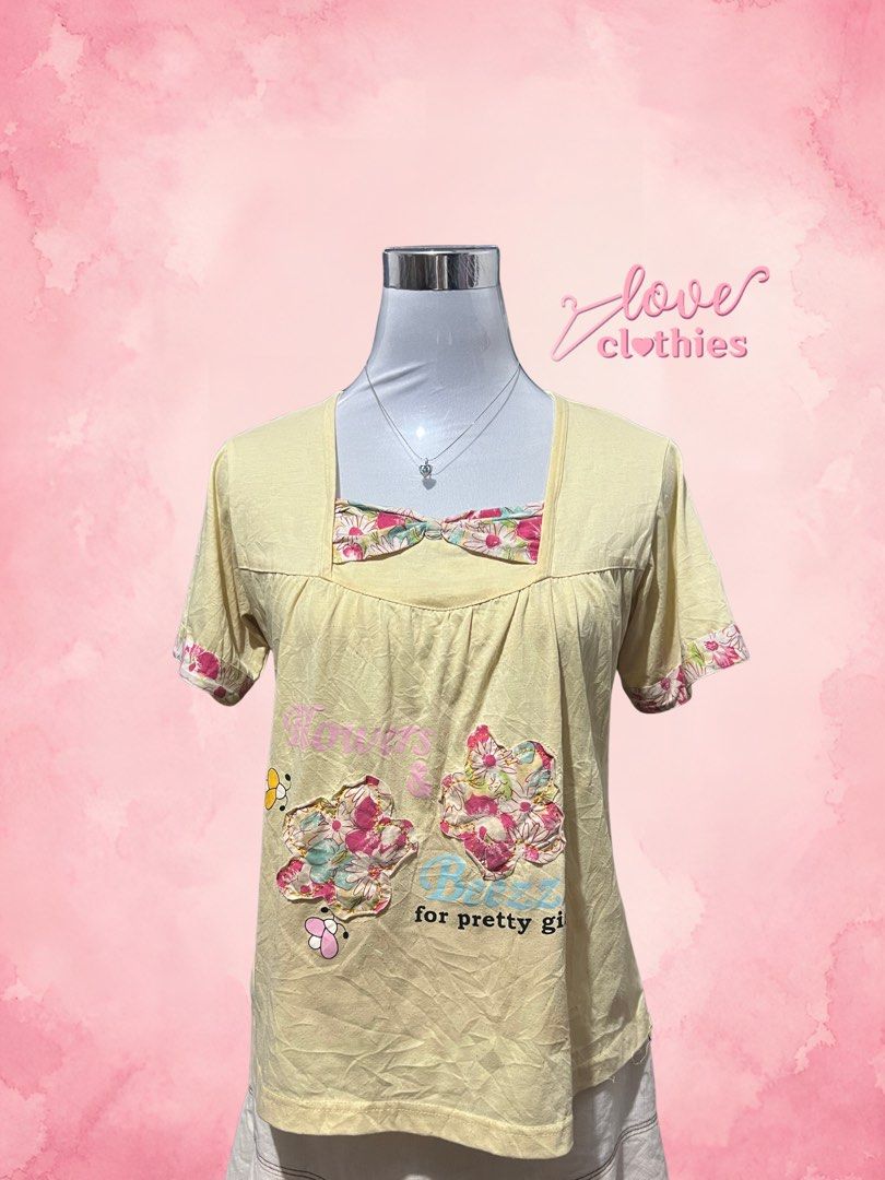 Yellow floral bow short sleeve top size M (Category: Blouses) located in Tuguegarao City. Submitted by love_clothies (Listing ID 1471069155, Image 1). Description: - Color: Yellow - Size: M - Material: Soft cotton fabric - Design: Square neckline with matching floral bow accent - Details: Floral patches near the bottom hem with text print - Fit: Comfortable fit - Condition: Brand new / Great casual piece for everyday wear.
