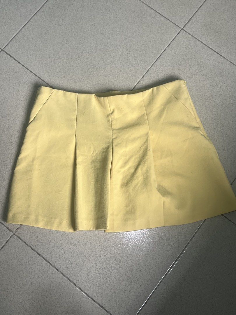 Yellow Pleated Skorts (Category: Skirts) located in Batangas. Submitted by alaisaampa7513 (Listing ID 1471028567, Image 1). Description: - Brand: Koton - Item: Bright yellow skorts (skirt look with shorts underneath) - Size: EUR 44 / D/CH 42 / UK 16 - Details: Front pleats, hidden side zipper closure - Condition: Clean fabric, no major flaws found - Perfect vibrant pop of color for sunny days!.
