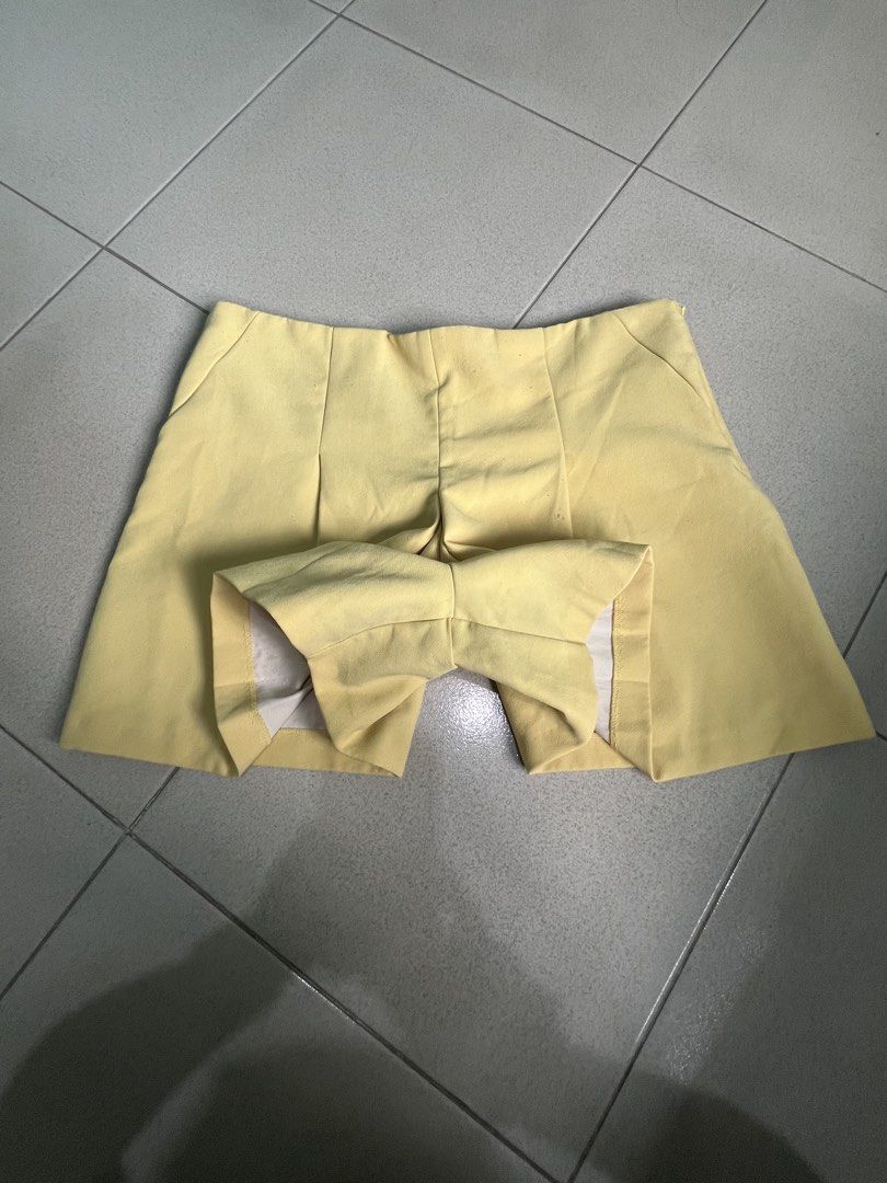 Yellow Pleated Skorts (Category: Skirts) located in Batangas. Submitted by alaisaampa7513 (Listing ID 1471028567, Image 2). Description: - Brand: Koton - Item: Bright yellow skorts (skirt look with shorts underneath) - Size: EUR 44 / D/CH 42 / UK 16 - Details: Front pleats, hidden side zipper closure - Condition: Clean fabric, no major flaws found - Perfect vibrant pop of color for sunny days!.