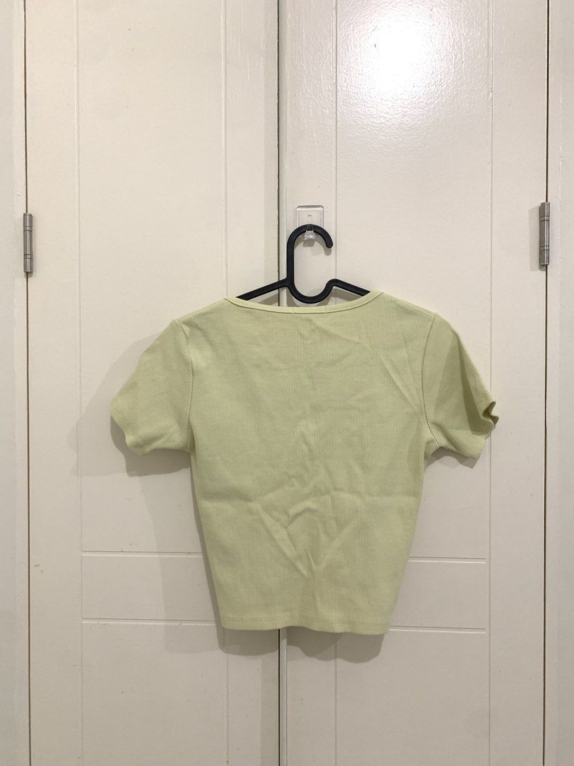 Yellow Ribbed V-Neck Ruched Crop Top (Category: Sleeveless) located in Pasig City. Submitted by lovedbyri (Listing ID 1470956249, Image 3). Description: - Size: Medium - Color: Light yellow - Material: Ribbed knit - Design: Short sleeves, V-neck, and adjustable front drawstring for a ruched style - Condition: Excellent, clean fabric with no stains or loose threads.
