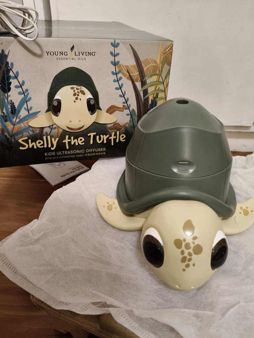 Young Living Shelly the Turtle Kids Ultrasonic Diffuser (Category: Home Fragrance) located in Manila. Submitted by eatsca_ (Listing ID 1470943841, Image 2). Description: - Brand: Young Living - Item: Kids Ultrasonic Diffuser (Green Turtle design) - Condition: 9/10 Almost new, used few times only. - Includes: Original box, AC power adapter, and operation manual - Features: Multiple mist output settings, 10 lighting options, and built-in white nois
