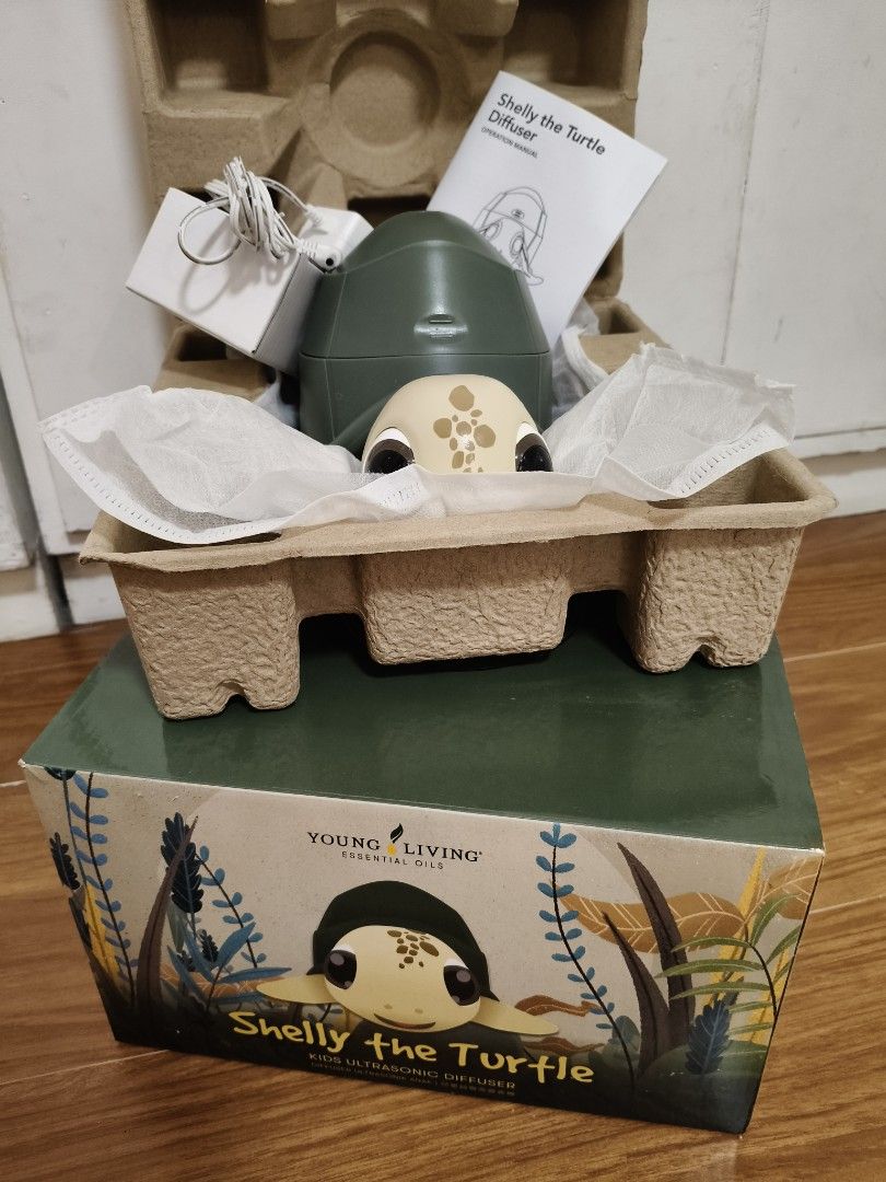 Young Living Shelly the Turtle Kids Ultrasonic Diffuser (Category: Home Fragrance) located in Manila. Submitted by eatsca_ (Listing ID 1470943841, Image 1). Description: - Brand: Young Living - Item: Kids Ultrasonic Diffuser (Green Turtle design) - Condition: 9/10 Almost new, used few times only. - Includes: Original box, AC power adapter, and operation manual - Features: Multiple mist output settings, 10 lighting options, and built-in white nois