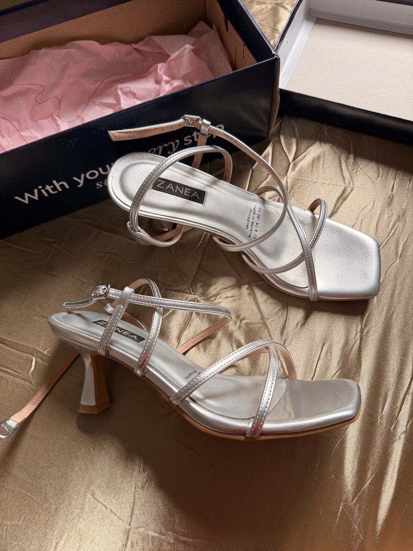 Zanea Silver Strappy Heels Size 7 (Category: Heels) located in Baguio. Submitted by nabiwuh.06 (Listing ID 1471019085, Image 2). Description: - Brand: Zanea (Made in Marikina) - Color/Material: Metallic silver - Size: 7 - Style: Slim curved heels, delicate crossover straps, square toes, adjustable ankle buckle - Used once only nung Graduation - Orig price: 1699 - Inclusions: Original SM Store box 📍Pangasinan/Baguio 🚚 JNT/LBC.