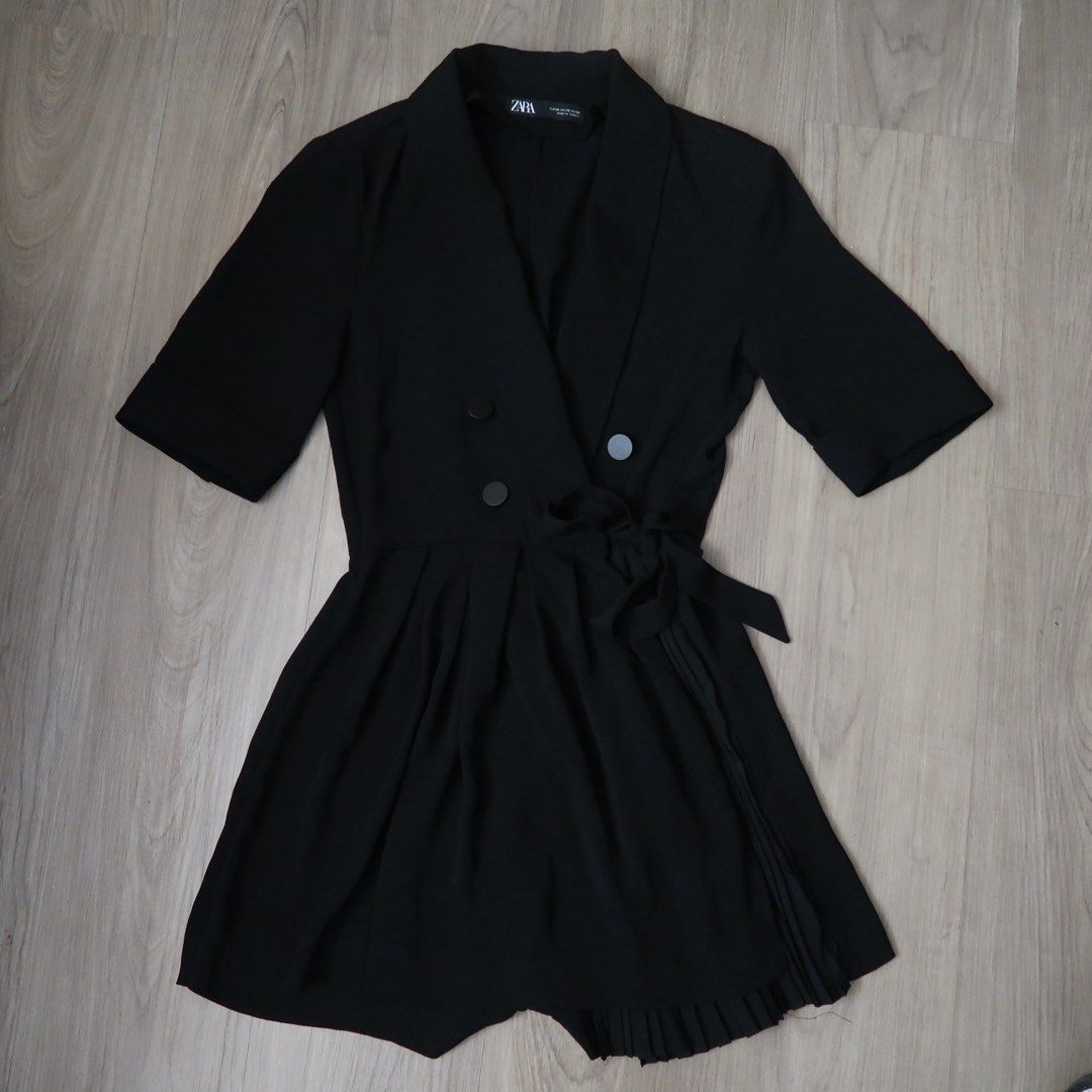 Zara Black Blazer Romper Playsuit Size XS (Category: Rompers) located in Manila. Submitted by mixi_lexi (Listing ID 1471039638, Image 1). Description: - Brand: Zara - Style: Black blazer playsuit with short sleeves and pleated skirt overlay - Features: Double-breasted front button closure, side tie belt - Size: XS - Origin: Made in Turkey - Condition: Great, clean, with no flaws.