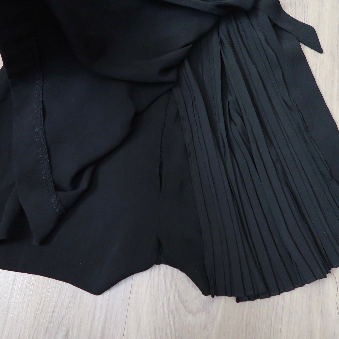 Zara Black Blazer Romper Playsuit Size XS (Category: Rompers) located in Manila. Submitted by mixi_lexi (Listing ID 1471039638, Image 3). Description: - Brand: Zara - Style: Black blazer playsuit with short sleeves and pleated skirt overlay - Features: Double-breasted front button closure, side tie belt - Size: XS - Origin: Made in Turkey - Condition: Great, clean, with no flaws.
