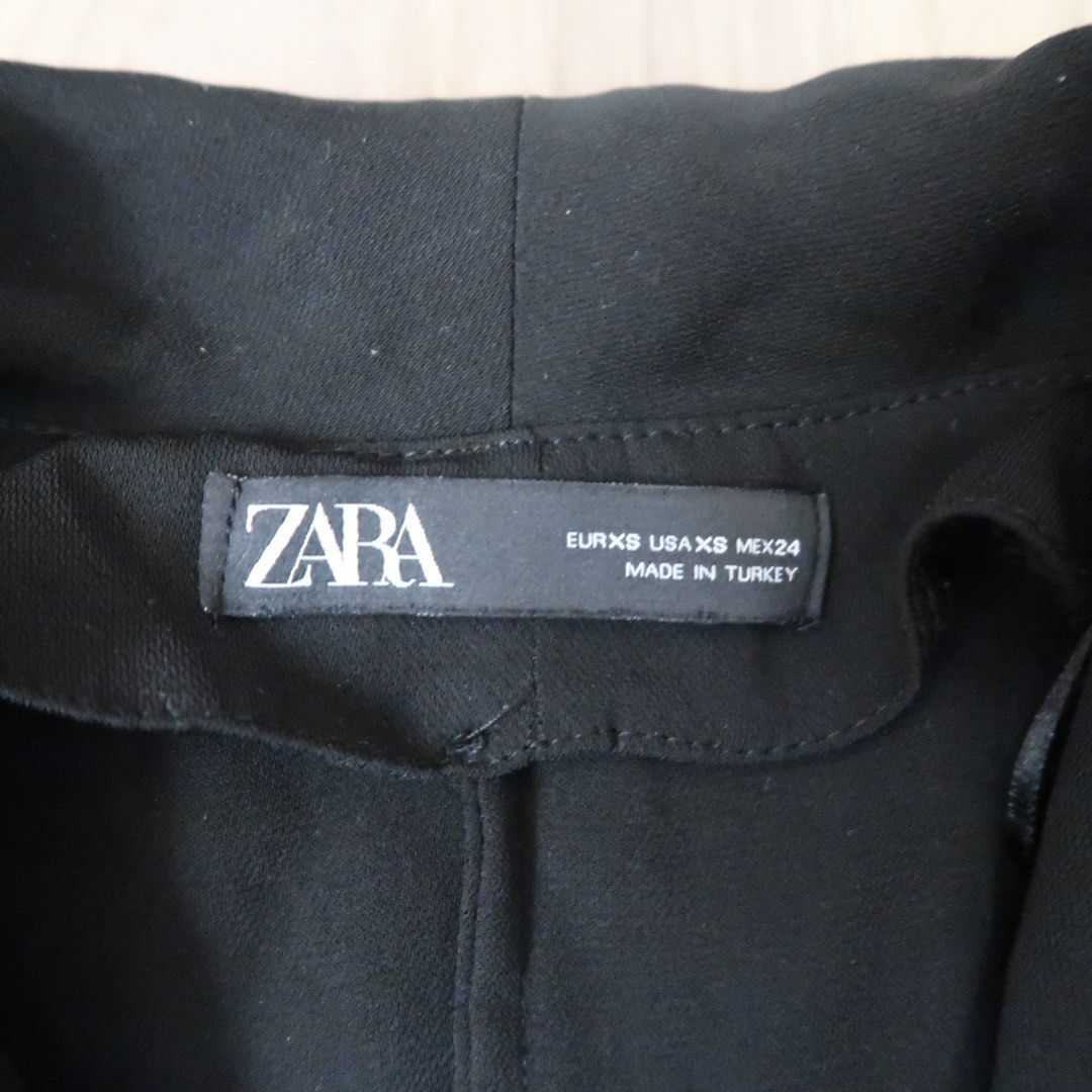 Zara Black Blazer Romper Playsuit Size XS (Category: Rompers) located in Manila. Submitted by mixi_lexi (Listing ID 1471039638, Image 2). Description: - Brand: Zara - Style: Black blazer playsuit with short sleeves and pleated skirt overlay - Features: Double-breasted front button closure, side tie belt - Size: XS - Origin: Made in Turkey - Condition: Great, clean, with no flaws.