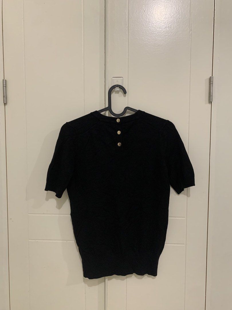 Zara Black Short Sleeve Knit Top Size S (Category: Blouses) located in Pasig City. Submitted by lovedbyri (Listing ID 1471009908, Image 3). Description: - Brand: Zara - Size: S (EUR/USA) - Color: Black - Material: Clean knit fabric - Design: Crew neck, short sleeves, ribbed hem and cuffs - Detail: Gold-tone button closures at the back neckline - Condition: Excellent, no pulls or damage - Style: Classic, versatile basic.