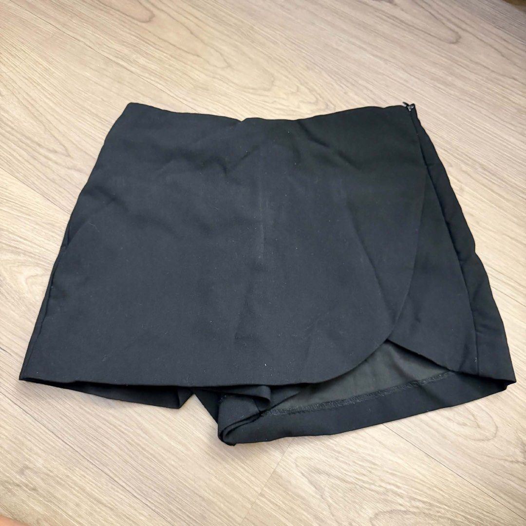 Zara black wrap skort size S (Category: Skirts) located in Manila. Submitted by mixi_lexi (Listing ID 1471045112, Image 1). Description: - Brand: Zara - Size: S - Color: Classic Black - Origin: Made in Turkey - Design: Wrap-front skirt with hidden shorts underneath - Closure: Convenient side zipper - Condition: Clean and ready to wear - Versatility: Perfect essential for casual days or nights out.