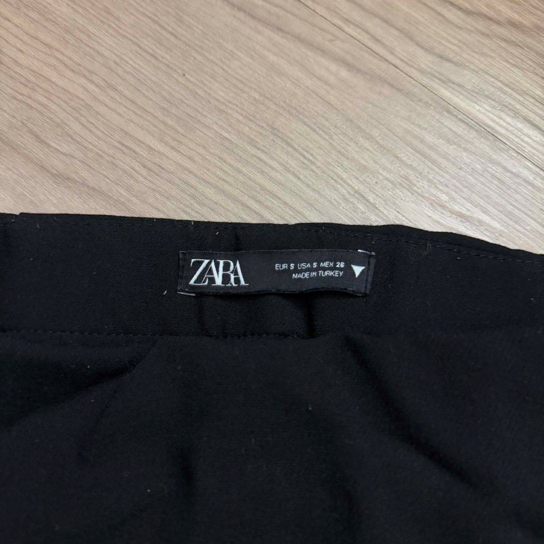 Zara black wrap skort size S (Category: Skirts) located in Manila. Submitted by mixi_lexi (Listing ID 1471045112, Image 2). Description: - Brand: Zara - Size: S - Color: Classic Black - Origin: Made in Turkey - Design: Wrap-front skirt with hidden shorts underneath - Closure: Convenient side zipper - Condition: Clean and ready to wear - Versatility: Perfect essential for casual days or nights out.