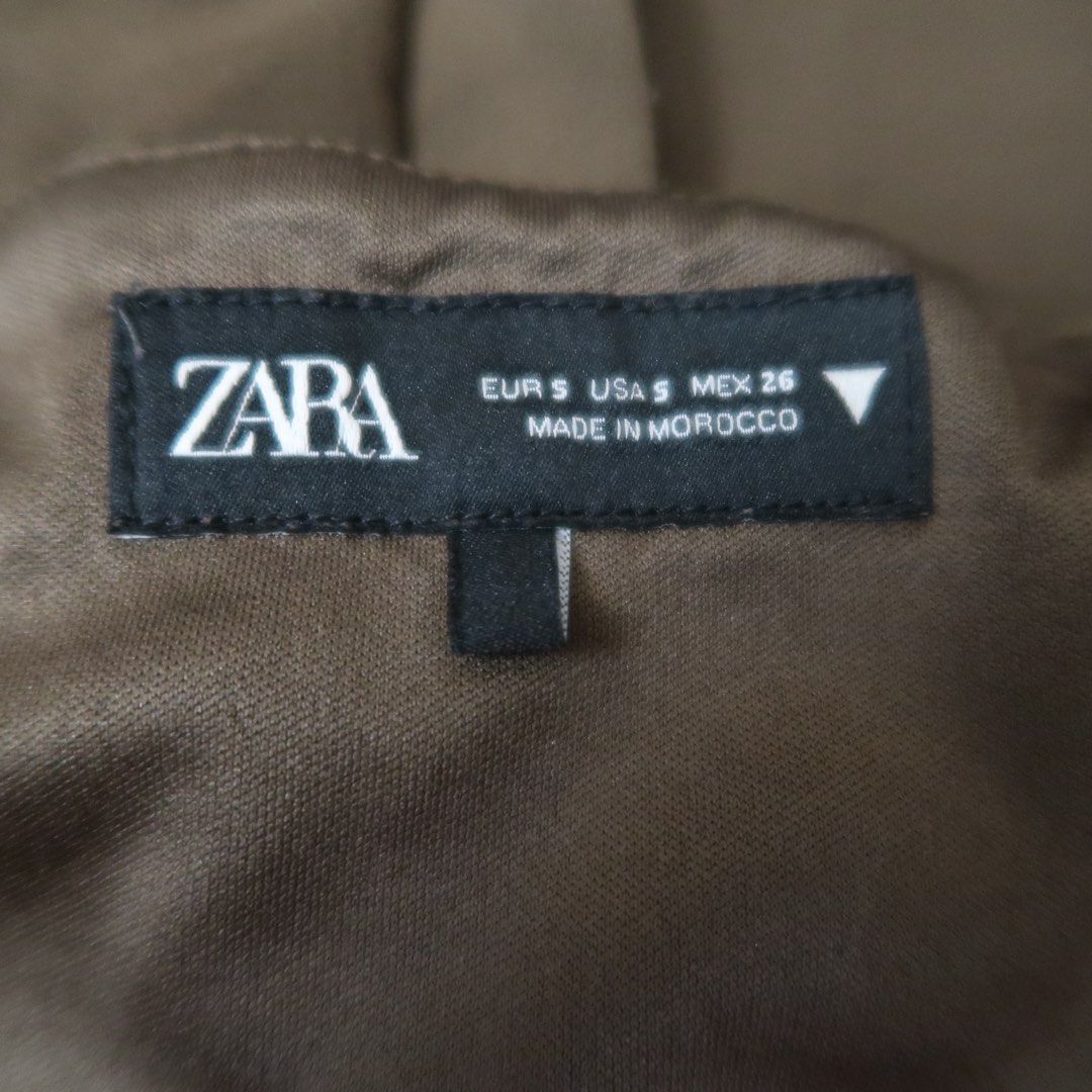 ZARA Brown Halter Vest Top Size S (Category: Sleeveless) located in Manila. Submitted by mairalyng21434 (Listing ID 1471038190, Image 2). Description: - Brand: Zara - Size: Small - Color: Brown - Origin: Made in Morocco - Design: Halter vest top with front button closure, utility pockets, strap detail, and open back - Styling tip: Pairs well with high-waisted jeans or trousers.