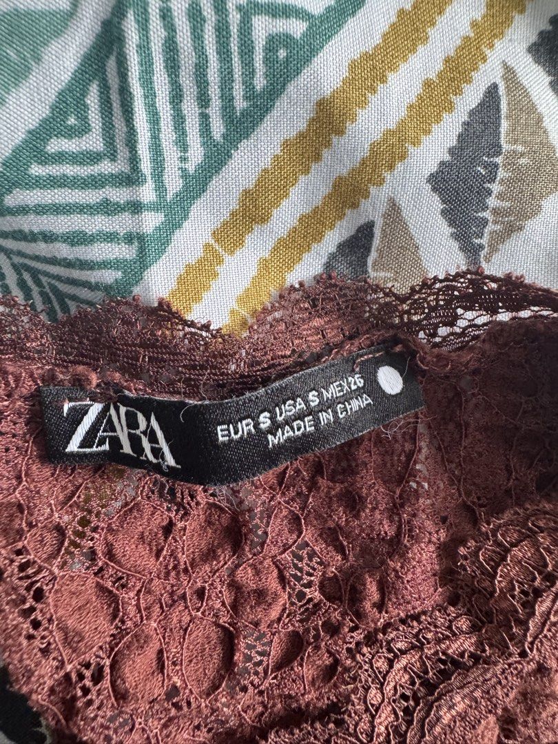 Zara Brown Lace Short Sleeve Top (Category: Blouses) located in Manila. Submitted by decluterthings888 (Listing ID 1470947814, Image 2). Description: - Brand: Zara - Item: Short sleeve lace top - Color: Dark brown - Size: S (fits true to size) - Material: Lightweight fabric with slight stretch - Details: Textured floral lace pattern, round neckline, small back cutout - Condition/Origin: Made in China - Styling: Great for layering or wearing on it