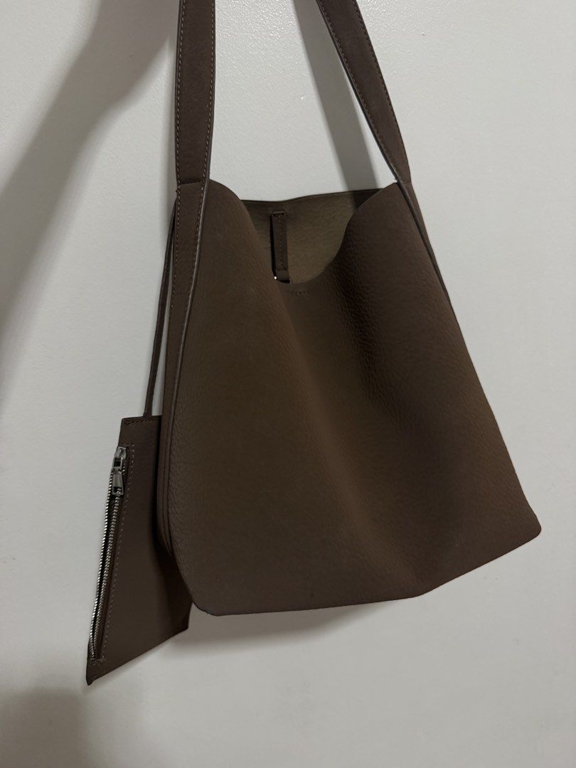 Zara Brown Shoulder Bag with Pouch (Category: Shoulder Bags) located in Las Pinas. Submitted by shopnshopperph (Listing ID 1471062559, Image 2). Description: - Brand: Zara - Style: Daily tote shoulder bag - Color: Versatile dark brown - Interior: Clean lining with a handy lobster clasp strap - Includes: Matching small zippered pouch hanging on the side - Condition: Tags attached with size and care instructions.