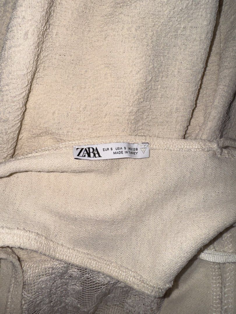 Zara Cream Textured Lace Romper Size S (Category: Rompers) located in Manila. Submitted by mixi_lexi (Listing ID 1471044936, Image 3). Description: - Brand/Model: Zara Cream Romper - Size: Small - Material: Textured fabric with front embroidered lace panels - Features: Deep V-neckline, sleeveless, adjustable tassel drawstring tie at the back - Origin: Made in Turkey - Condition: Clean and in great shape.