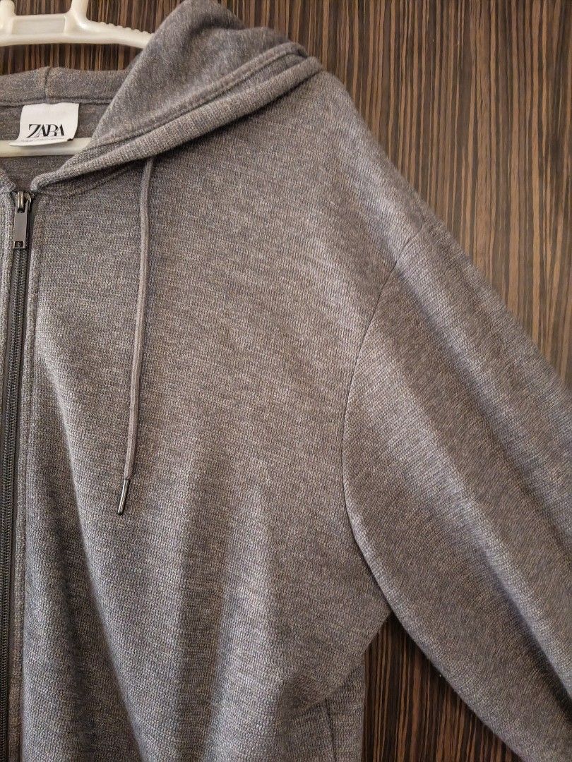 Zara Grey Zip-Up Hoodie Medium (Category: Coats, Jackets and Outerwear) located in Las Pinas. Submitted by sam_twin_d (Listing ID 1471021962, Image 2). Description: - Brand: Zara - Size: M - Color: Grey - Material: Textured knit (Made in Pakistan) - Features: Full metal zip closure, drawstring hood, front pockets - Fit: Regular fit, perfect for layering in cool weather.