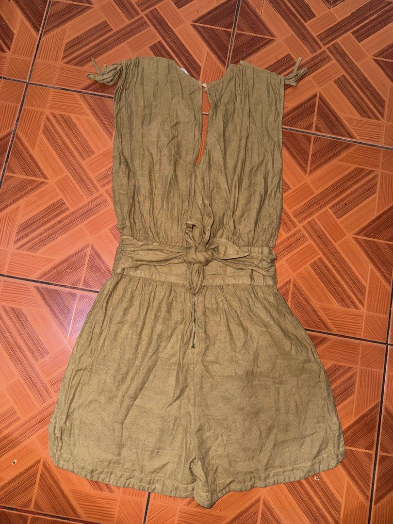 Zara mustard yellow linen romper playsuit (Category: Rompers) located in Manila. Submitted by maira_lucero (Listing ID 1471044954, Image 2). Description: - Brand: Zara - Size: XS - Color: Mustard Yellow - Material: Textured linen (Made in Morocco) - Design: Deep V-neckline with adjustable shoulder tie straps - Waist: Fitted with a matching self-tie back sash - Closure: Lower back zipper - Condition: Excellent, perfect for warm weather days.