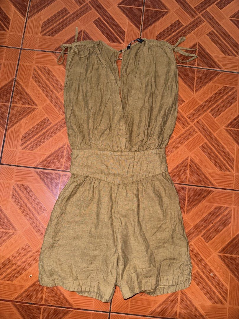 Zara mustard yellow linen romper playsuit (Category: Rompers) located in Manila. Submitted by maira_lucero (Listing ID 1471044954, Image 1). Description: - Brand: Zara - Size: XS - Color: Mustard Yellow - Material: Textured linen (Made in Morocco) - Design: Deep V-neckline with adjustable shoulder tie straps - Waist: Fitted with a matching self-tie back sash - Closure: Lower back zipper - Condition: Excellent, perfect for warm weather days.