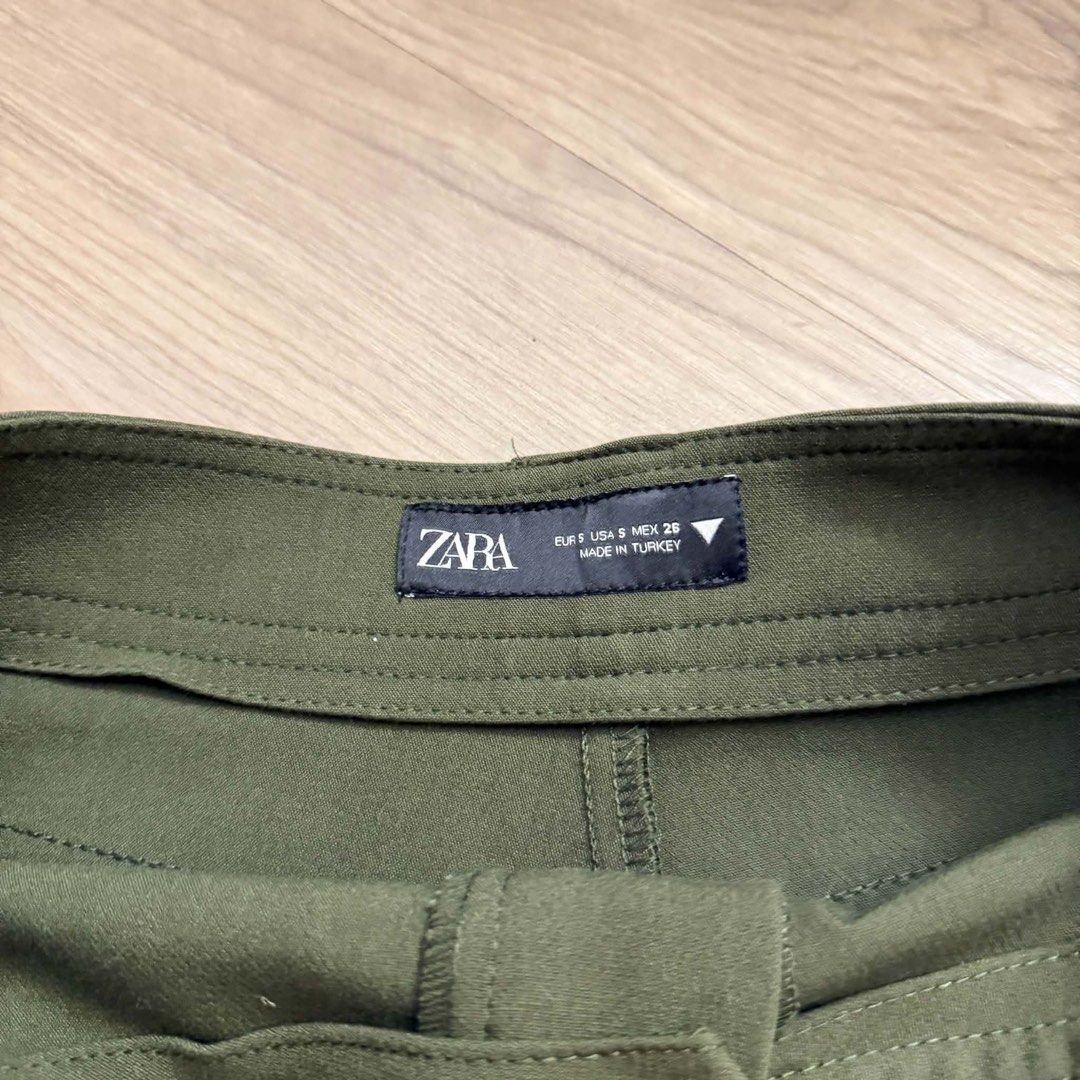 ZARA Olive Green Cargo Skort Size S (Category: Skirts) located in Manila. Submitted by mixi_lexi (Listing ID 1471045079, Image 2). Description: - Brand: ZARA - Size: S (EUR S, USA S, MEX 26) - Color: Olive Green - Design: High waist with belt loops, front skirt overlay with hidden shorts underneath - Pockets: Practical cargo pockets on both sides - Origin: Made in Turkey - Condition/Style: Clean fabric, great staple piece for casual outfits.