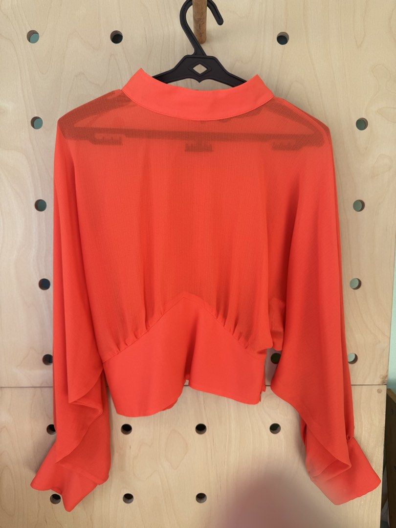 ZARA Red High Neck Blouse Size S (Category: Blouses) located in Makati City. Submitted by thevclosetph (Listing ID 1470933249, Image 1). Description: - Brand: ZARA - Size: EUR S / USA S / MEX 26 - Color: Bright red (sheer fabric) - Details: High neckline, back button closure, long bishop sleeves with fitted cuffs, cropped fit - Origin: Made in Turkey.