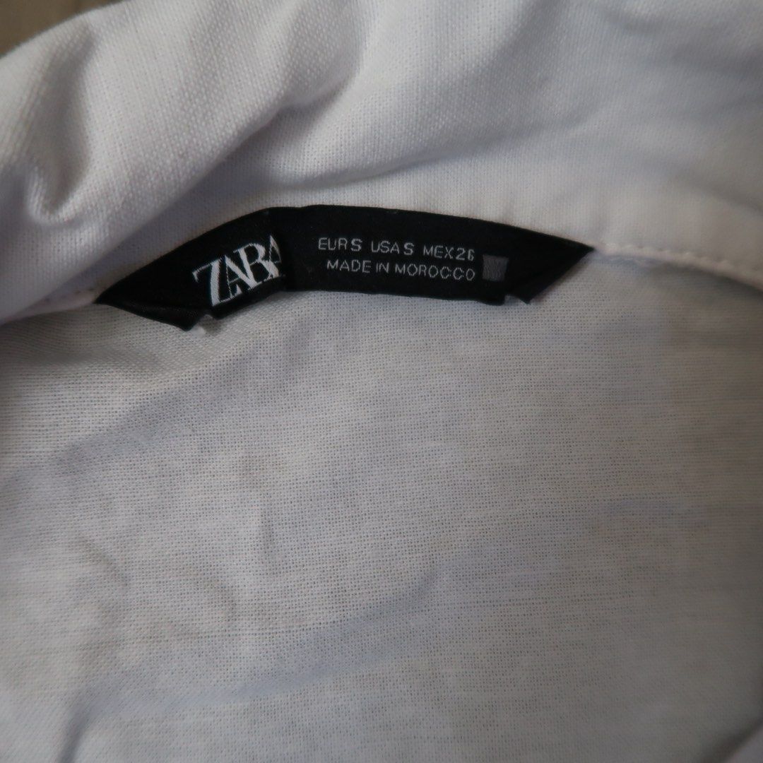 Zara White Cropped Shirt Size S (Category: Shirts) located in Manila. Submitted by mixi_lexi (Listing ID 1471034948, Image 2). Description: - Brand: Zara - Style: Cropped button-down shirt with long sleeves and button cuffs - Size: Small (EUR, USA, MEX tags) - Material: Lightweight cotton - Details: Two front flap pockets, made in Morocco - Condition: Clean, excellent everyday basic piece for layering or solo wear.