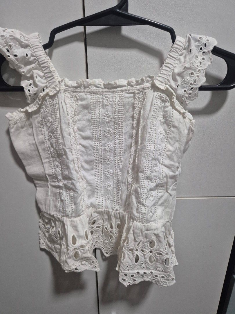 Zara White Eyelet Top Size 13-14 (Category: Babies & Kids Fashion) located in Batangas. Submitted by marthy2009 (Listing ID 1471003587, Image 1). Description: - Brand: Zara - Style: Off-shoulder crop top with intricate eyelet lace embroidery and floral patterns - Details: Elasticated ruffled neckline, short sleeves, lightweight cotton fabric with textured panels - Size: 13-14 cm - Origin: Made in India.