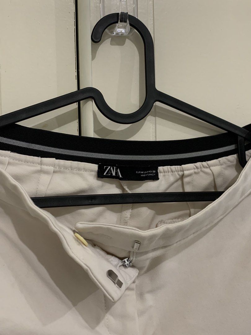 Zara White Trousers Size M (Category: Jeans) located in Pasig City. Submitted by lovedbyri (Listing ID 1471031737, Image 2). Description: - Brand: Zara - Size: M - Color: White with contrast black and white striped elastic waistband - Details: Front side pockets, back welt pockets, zip fly with hook and bar closure - Origin: Made in Turkey - Style: Clean minimalist look, easy to dress up or down for work or casual outings.