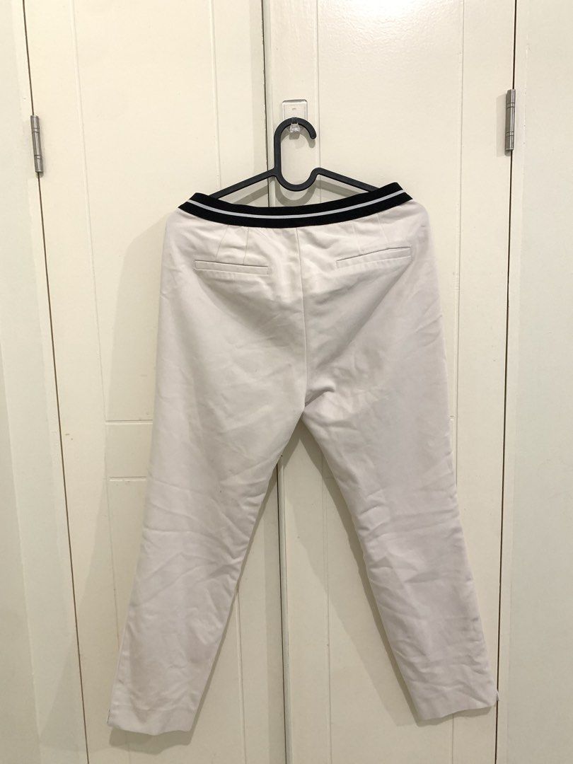 Zara White Trousers Size M (Category: Jeans) located in Pasig City. Submitted by lovedbyri (Listing ID 1471031737, Image 3). Description: - Brand: Zara - Size: M - Color: White with contrast black and white striped elastic waistband - Details: Front side pockets, back welt pockets, zip fly with hook and bar closure - Origin: Made in Turkey - Style: Clean minimalist look, easy to dress up or down for work or casual outings.
