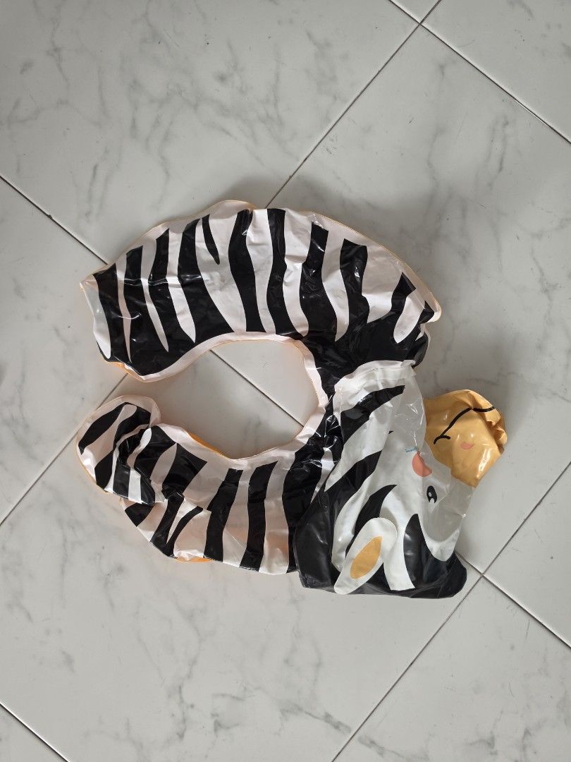 Zebra inflatable pool float neck ring (Category: Water Sports) located in Singapore. Submitted by m.bharath (Listing ID 1471035130, Image 1). Description: - Fun zebra design with black and white stripes and a cute animal head - Ideal for pool days, beach trips, and water fun for kids - Packs down small for easy travel and storage - Lightweight and super easy to bring along anywhere.