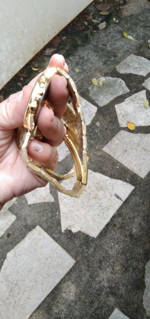 2 pcs watches Set old stock (Category: Women's Watches) located in Quezon City. Submitted by eidorableshop (Listing ID 1465703181, Image 2). Description: - Set of 2 brand new gold-tone wristwatches with protective plastic still attached - Left watch: Geneva brand, white dial, classic Roman numerals, and three decorative sub-dials - Right watch: Timeless Manila brand, rich dark brown dial with chronograph-style pushers - Straps: Matching metallic 
