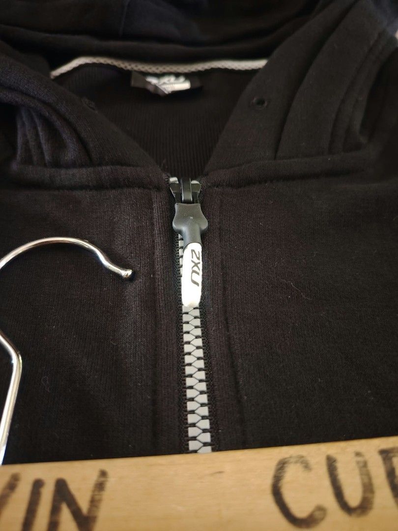 2XU Black Zip-Up Hoodie (Category: Coats, Jackets and Outerwear) located in Nasipit. Submitted by edwingonzales498-69377 (Listing ID 1465626422, Image 3). Description: - Brand: 2XU - Color: Black with white sleeve graphics and zipper detail - Size: Small (Width: 20 inches, Length: 23 inches) - Material: Soft and comfortable fabric - Versatile: Great for workouts or casual everyday wear.