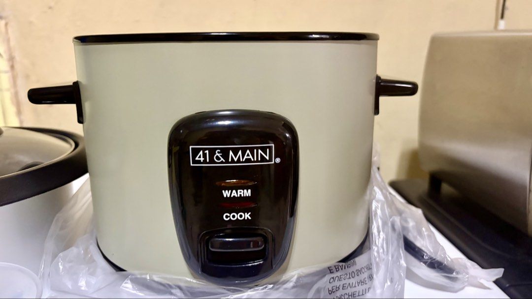 41 & Main 3 Cup Rice Cooker (Category: Cookers) located in Manila. Submitted by lizziedear.lizziedear (Listing ID 1465640968, Image 1). Description: - Brand: 41 & Main - Capacity: Compact 3-cup size, ideal for singles or small households - Color: Aesthetic cream-colored exterior with black accents and glass lid - Features: Easy cook and warm modes with clear indicator lights - Inclusions: Comes with a measuring cup, rice paddle, and original box 