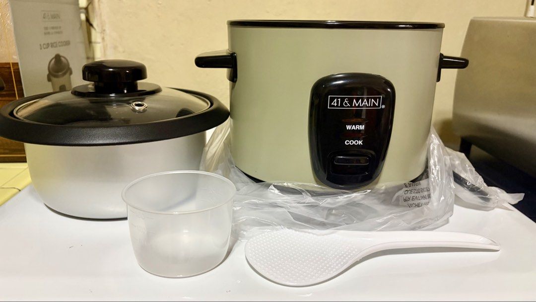 41 & Main 3 Cup Rice Cooker (Category: Cookers) located in Manila. Submitted by lizziedear.lizziedear (Listing ID 1465640968, Image 2). Description: - Brand: 41 & Main - Capacity: Compact 3-cup size, ideal for singles or small households - Color: Aesthetic cream-colored exterior with black accents and glass lid - Features: Easy cook and warm modes with clear indicator lights - Inclusions: Comes with a measuring cup, rice paddle, and original box 