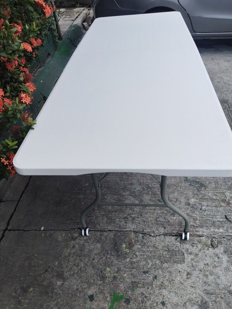 6ft White Foldable Utility Table with Wheels (Category: Tables & Sets) located in Cavite. Submitted by ambersaints (Listing ID 1465625181, Image 2). Description: - Storage: Folds down in the middle for space-saving storage and transport.