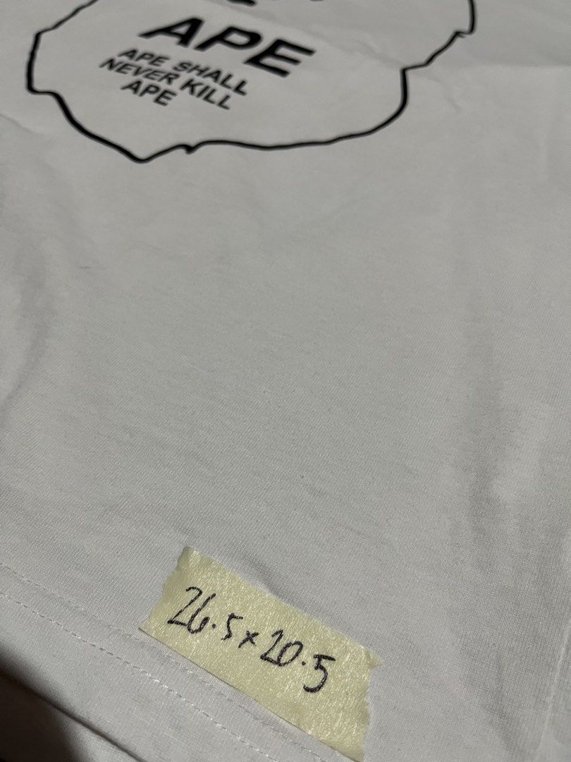 A Bathing Ape BAPE White Graphic Tee Size 2XL (Category: Tshirts & Polo Shirts ) located in Cavite. Submitted by christianzuuu (Listing ID 1465730432, Image 3). Description: - Dimes on actual photo - Brand: A Bathing Ape (BAPE) - Color: White - Size: 2XL (Measurements shown in photos) - Material: 100% Cotton - Design: Large Ape head graphic with 'Ape Shall Never Kill Ape' text - Condition: Brand new with classic collar and sleeve tags - Guarantee