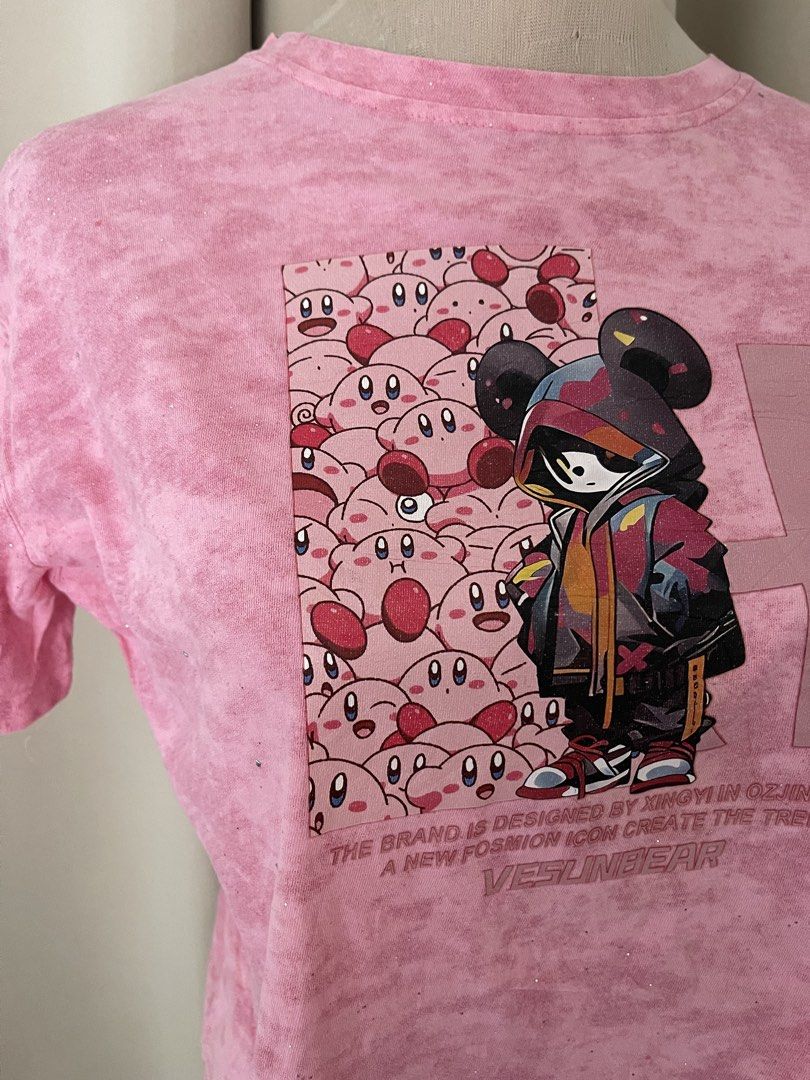 acidwash Kirby Graphic Crop Tee (Category: Shirts) located in Cainta. Submitted by zlove111 (Listing ID 1465585293, Image 2). Description: - Style: Streetwear cropped tee - Design: Pink tie-dye with cute Kirby characters and masked hoodie graphic - Details: "Vesunbear" text at the bottom - Fit: Cropped length, short sleeves, crew neckline - Condition: Excellent / As good as new - Shipping: Ships locally within the Philippines via J&T Express smal