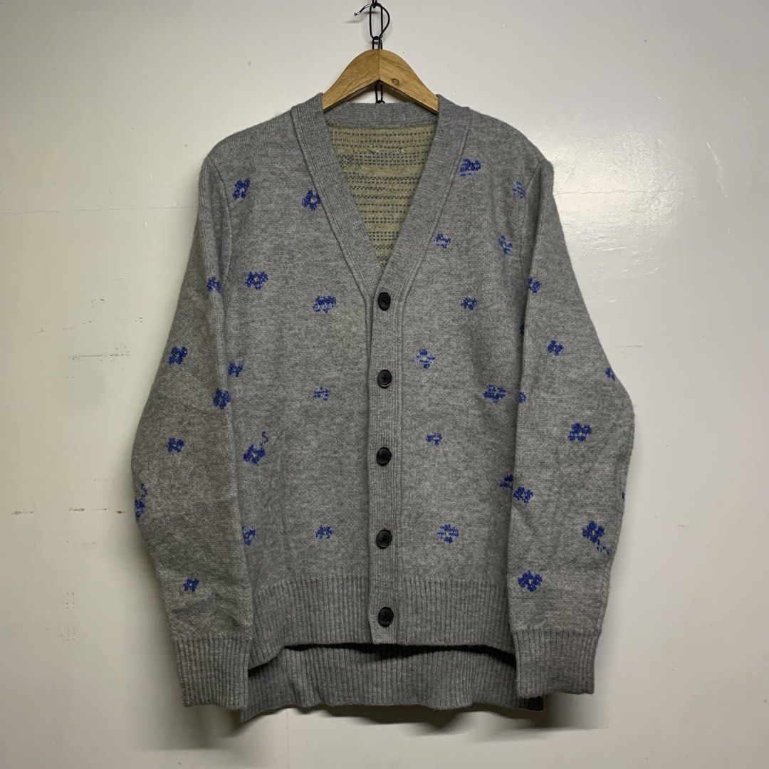 Ader Error Grey Wool Floral Cardigan Size A1 (Category: Coats, Jackets and Outerwear) located in Manila. Submitted by grapplers.gallery (Listing ID 1465742768, Image 1). Description: - Brand: Ader Error (2020 Season) - Item: Grey wool cardigan with all-over blue floral jacquard pattern and yellow center details - Material: 100% Wool - Size: A1 - Details: V-neck, button-up front with ADER branded buttons, and signature leather tag at the back neck