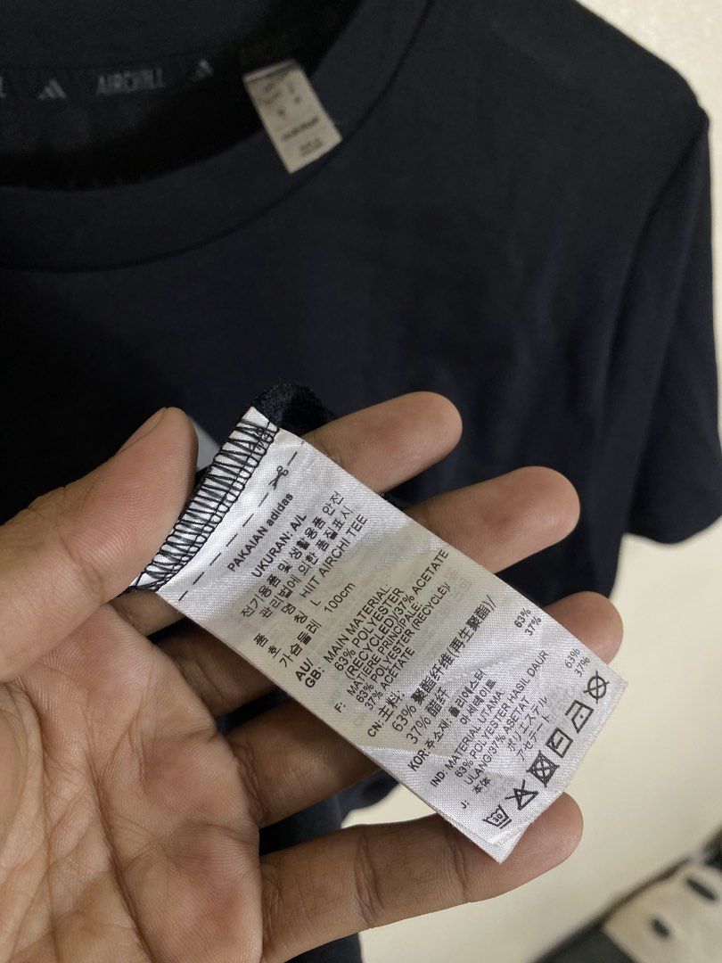 Adidas Aichill HIIT Tee Dark Navy Size L (Category: Activewear) located in Manila. Submitted by carbertjakosalem (Listing ID 1465754592, Image 3). Description: - Brand: Adidas Aichill HIIT Tee - Color: Dark Navy with reflective center chest logo - Size: Asia A/L (180/100A), US Size XL - Material: 63% recycled polyester, 37% acetate (lightweight & breathable with inner collar mesh) - Condition: Brand new with clean tags attached - Origin: Made in 