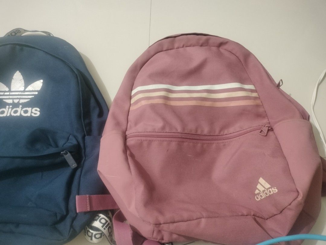 Adidas Backpack Bundle Set Blue and Pink (Category: Backpacks) located in Imus. Submitted by emershop (Listing ID 1465650112, Image 2). Description: - Authentic Adidas Backpack Bundle (Set of 2) - Colors: Classic Navy Blue & Dusty Rose Pink - Navy bag features a large trefoil logo and branded strap details - Dusty rose bag features a stylish striped pattern and subtle lower logo - Convenient front zippered pocket on both bags - Adjustable shoulde