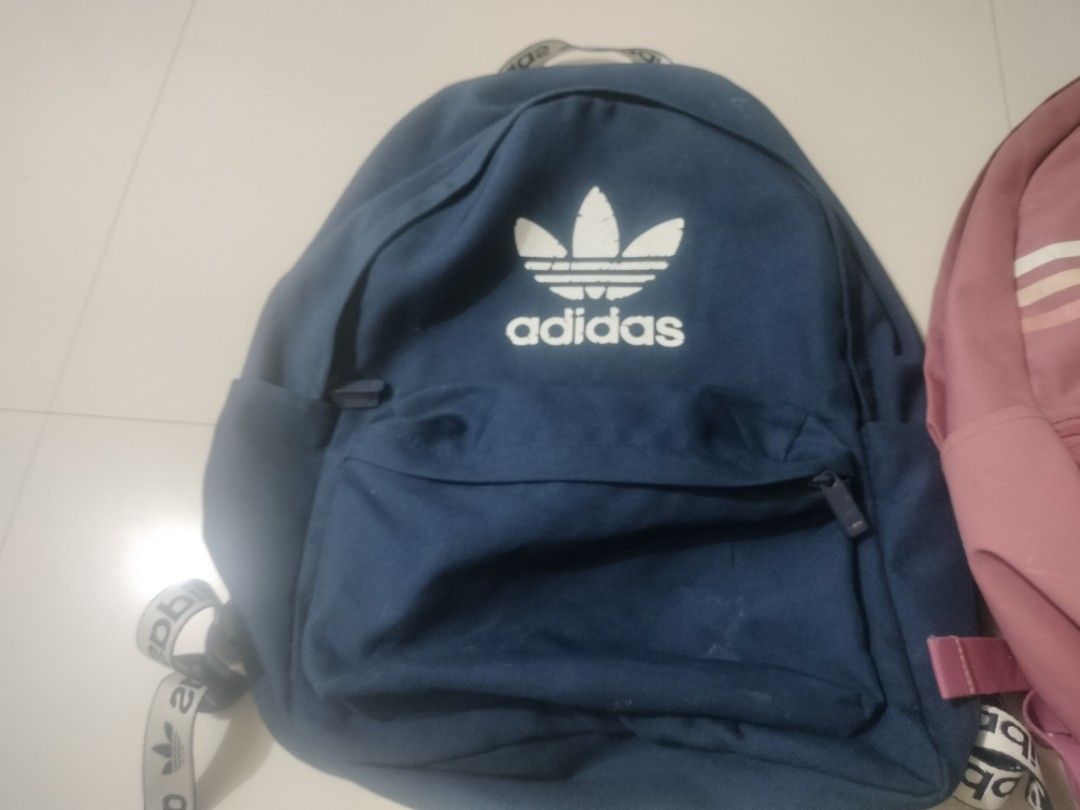Adidas Backpack Bundle Set Blue and Pink (Category: Backpacks) located in Imus. Submitted by emershop (Listing ID 1465650112, Image 3). Description: - Authentic Adidas Backpack Bundle (Set of 2) - Colors: Classic Navy Blue & Dusty Rose Pink - Navy bag features a large trefoil logo and branded strap details - Dusty rose bag features a stylish striped pattern and subtle lower logo - Convenient front zippered pocket on both bags - Adjustable shoulde