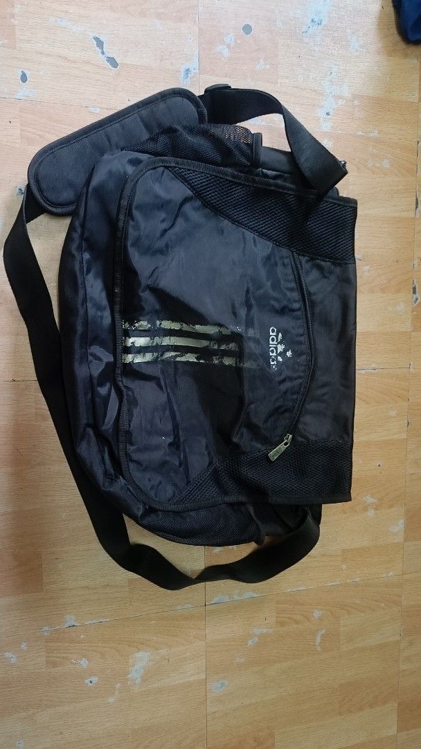 Adidas Black Messenger Bag with Shoulder Strap (Category: Sling Bags) located in Manila. Submitted by mavs12 (Listing ID 1465613892, Image 1). Description: - Brand: Adidas - Color: Classic Black - Design: Messenger bag with front flap, mesh details, and signature 3-stripes branding - Comfort: Adjustable shoulder strap with a supportive padded shoulder pad - Storage: Spacious main compartment ideal for daily use, school, or gym gear - Accessibilit