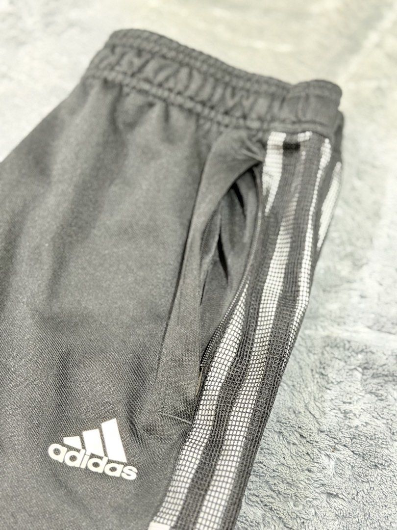Adidas Black Track Pants with White Stripes (Category: Joggers) located in Tagaytay City. Submitted by belletrendss (Listing ID 1465654918, Image 3). Description: - Classic black Adidas track pants with iconic white stripes - Zippered side pockets to keep your essentials secure - Ankle zippers for an adjustable, customizable fit - Comfortable elastic waistband for all-day wear - Versatile staple piece ideal for workouts or streetwear.
