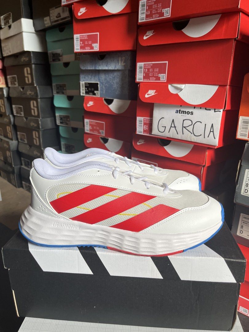 Adidas Game Chaser White Red Blue Sneakers (Category: Sneakers) located in Valenzuela. Submitted by rr.sneakerstash (Listing ID 1465585680, Image 1). Description: - Color: White mesh with bold red stripes and yellow contrast stitching - Comfort: Lightmotion midsole for solid cushioning - Grip: Blue rubber traction outsole - Closure: Lace-up with white laces - Condition: Pristine, clean upper - Best for: Daily walking or casual wear.