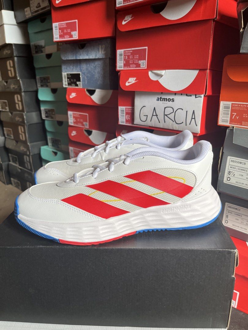 Adidas Game Chaser White Red Blue Sneakers (Category: Sneakers) located in Valenzuela. Submitted by rr.sneakerstash (Listing ID 1465585680, Image 2). Description: - Color: White mesh with bold red stripes and yellow contrast stitching - Comfort: Lightmotion midsole for solid cushioning - Grip: Blue rubber traction outsole - Closure: Lace-up with white laces - Condition: Pristine, clean upper - Best for: Daily walking or casual wear.